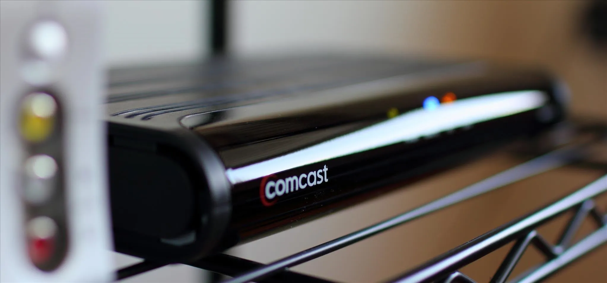Digital cable box on a shelf.