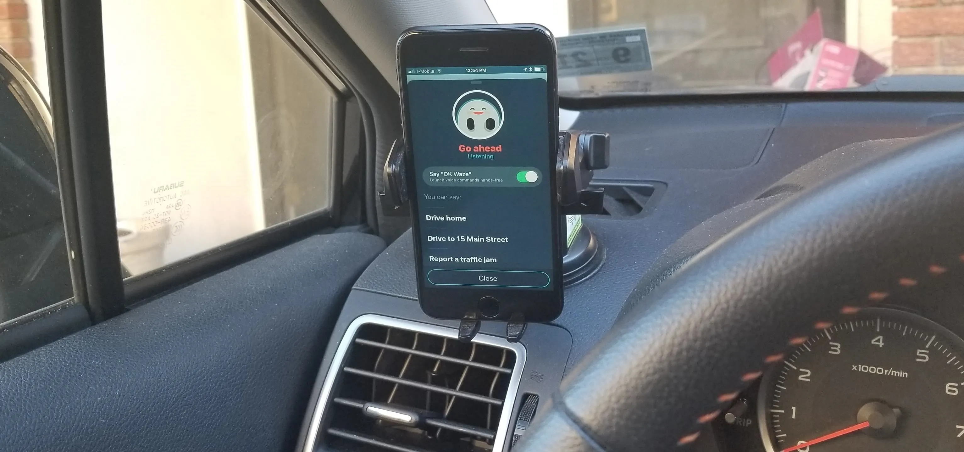 Smartphone mounted on a car dashboard displaying a navigation app.