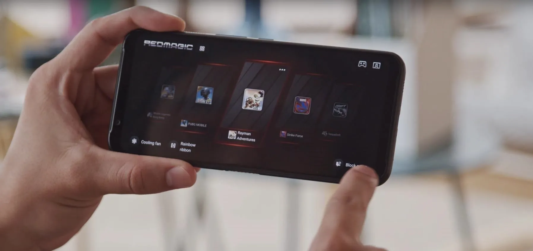 A person holding a smartphone displaying a gaming interface.